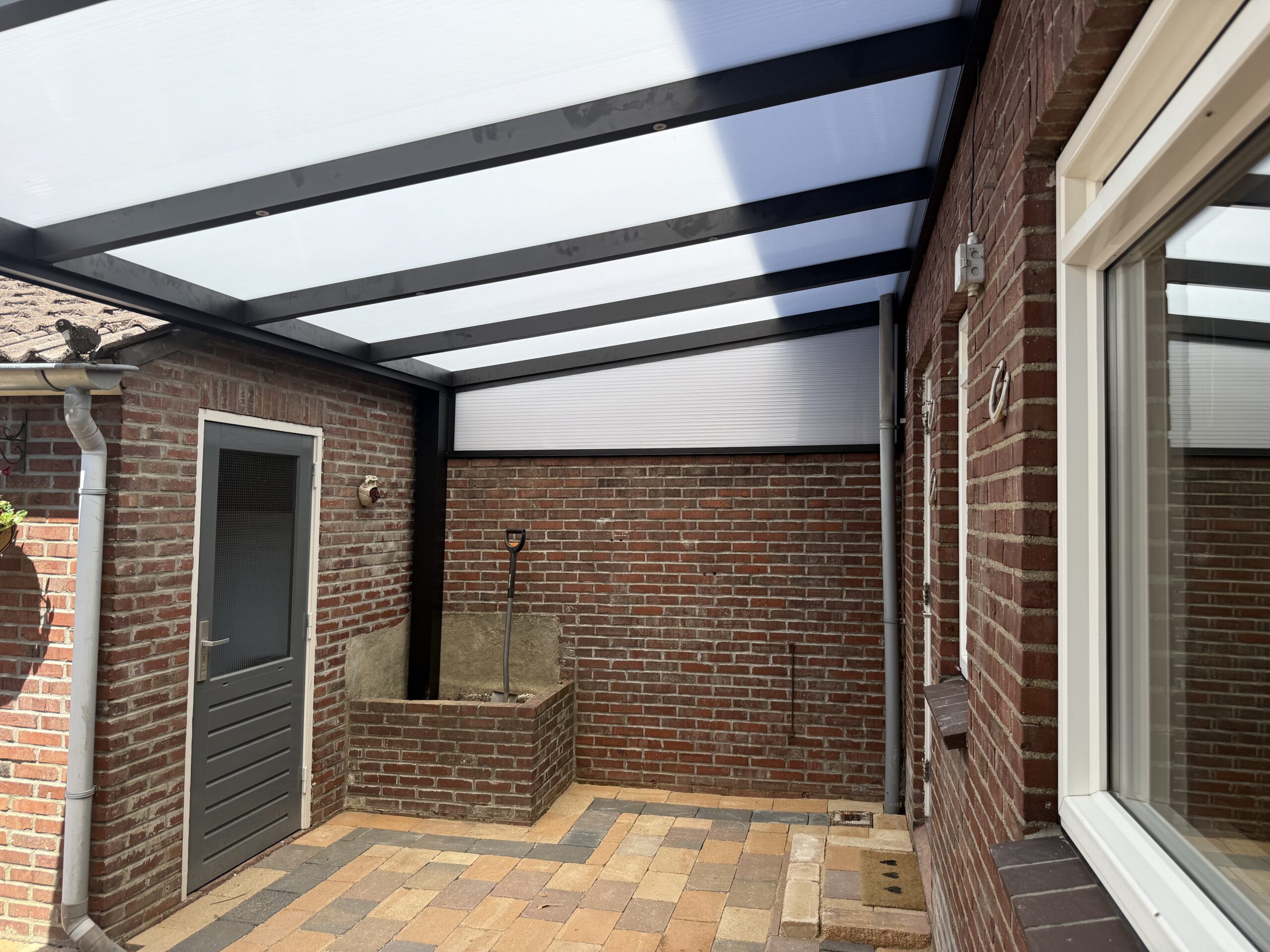 Veranda met glazen schuifwanden geplaatst door AluSolutions